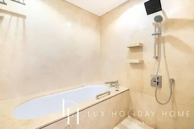 a bathroom with a bath tub and a shower at LUX The JW Marina Suite 2 in Dubai