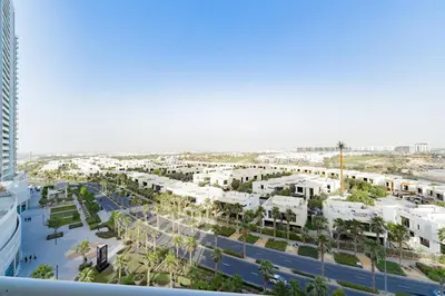 an aerial view of a city with palm trees and buildings at Elegant Studio in Damac Hills - Exclusive Living with Premium Amenities, Managed by Think Realty in Dubai