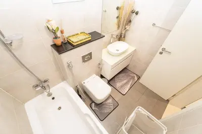a small bathroom with a toilet and a sink at Elegant Studio in Damac Hills - Exclusive Living with Premium Amenities, Managed by Think Realty in Dubai