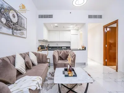 a living room with a couch and a table at Modern High Floor Canal View1 BHK in Dubai