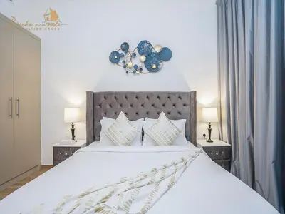 a bedroom with a large white bed with two night stands at Modern High Floor Canal View1 BHK in Dubai