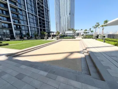 a sidewalk in a city with tall buildings at Elegant 1 Bedroom in Creek Edge in Dubai