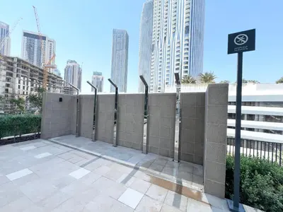 a retaining wall with a bike sign in a city at Elegant 1 Bedroom in Creek Edge in Dubai