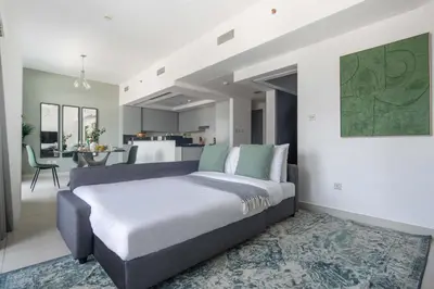 a bedroom with a large bed and a kitchen at Frank Porter - The Lofts Central Tower in Dubai