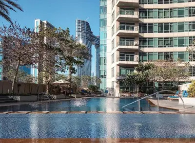 a swimming pool in a city with tall buildings at Frank Porter - The Lofts Central Tower in Dubai