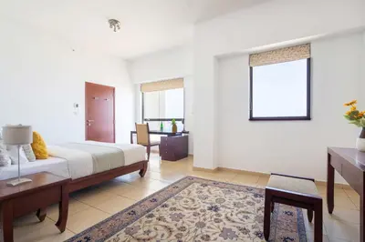 a bedroom with a bed and a living room at Frank Porter - Sadaf 6 in Dubai