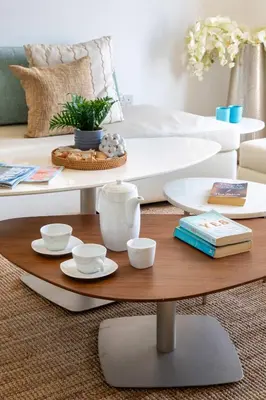 a living room with a coffee table and a bed at Frank Porter - Sadaf 6 in Dubai