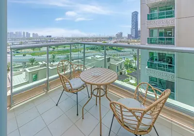 a balcony with a table and chairs and a view of a city at 2BR Dubai Marina Apt - Walk to Metro - Pool and Gym in Dubai