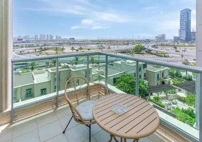 a balcony with a table and chairs and a view of a city at 2BR Dubai Marina Apt - Walk to Metro - Pool and Gym in Dubai