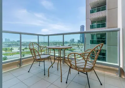 a table and chairs on a balcony with a view at 2BR Dubai Marina Apt - Walk to Metro - Pool and Gym in Dubai