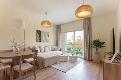 a living room with a couch and a table at HAVN - 1 Bedroom in The Greens, Barsha Heights in Dubai