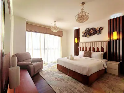 a hotel room with a bed and a couch at ELAN RIMAL MURJAN Suites in Dubai