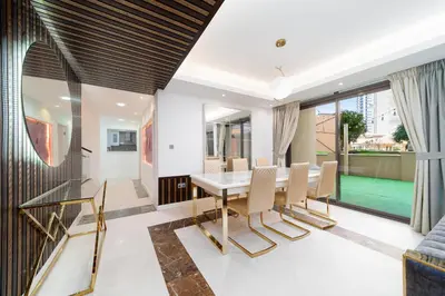 a dining room with a table and chairs at ELAN RIMAL MURJAN Suites in Dubai