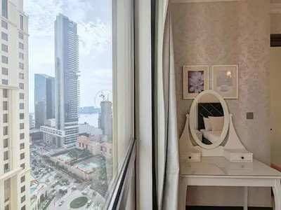 a room with a view of a city from a window at ELAN RIMAL MURJAN Suites in Dubai