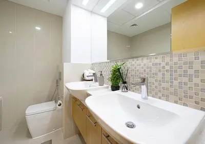 a bathroom with a sink and a toilet and a mirror at Magnificent 4 Bedroom Apartment, Bellevue Tower in Dubai