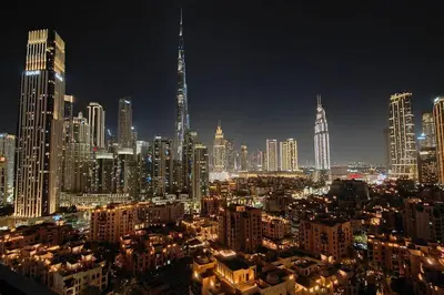 a night view of a large city with tall buildings at Magnificent 4 Bedroom Apartment, Bellevue Tower in Dubai