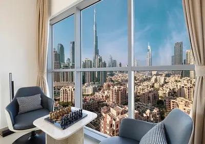 a room with a large window with a view of a city at Magnificent 4 Bedroom Apartment, Bellevue Tower in Dubai