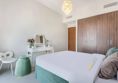 a bedroom with a bed and a table and a chair at Luxurious 1 Bed in Dubai Creek Harbor, Hosted by Desert City Stays in Dubai