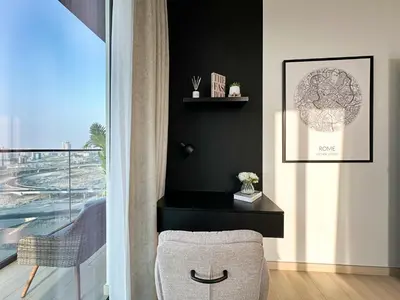 a living room with a chair and a window at Shadow Lounge Suites Work Station & Dubai Skyline Views in Dubai