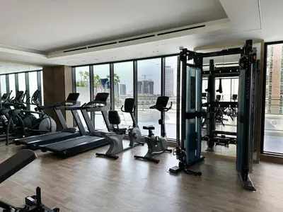 a gym with treadmills and exercise equipment in a building at Shadow Lounge Suites Work Station & Dubai Skyline Views in Dubai