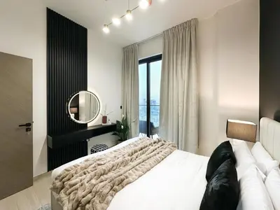 a bedroom with a large bed and a mirror at Shadow Lounge Suites Work Station & Dubai Skyline Views in Dubai