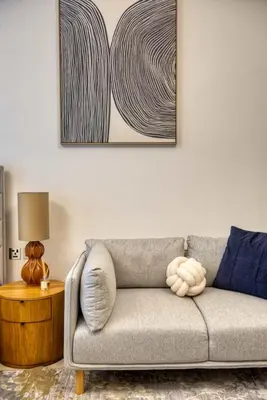 a living room with a couch and a picture on the wall at Elegant studio in Me Do Re Tower in Dubai