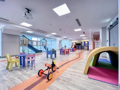 a childrens play area with a toy bike in a room at Elegant studio in Me Do Re Tower in Dubai