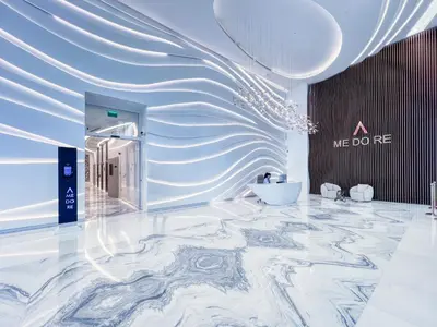 a lobby with a marble floor and a me do ne sign at Elegant studio in Me Do Re Tower in Dubai