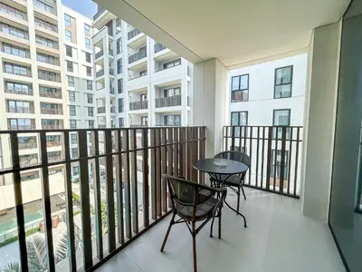 a balcony with a table and chairs in a apartment at Elegant 1 Bedroom at Creek Beach Bayshore in Dubai