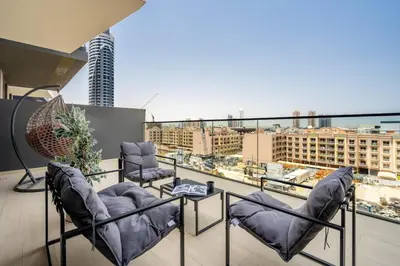 a balcony with chairs and a view of a city at GuestReady - Charming haven at Binghatti Crest in Dubai