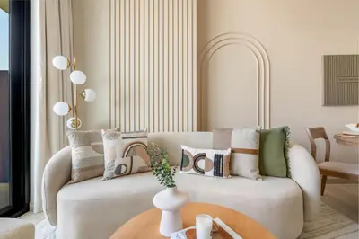 a living room with a couch with pillows on it at GuestReady - Charming haven at Binghatti Crest in Dubai