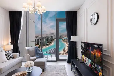 a living room with a tv and a large window at Crystal Lagoon View Beach access Fast Wi-Fi in Dubai