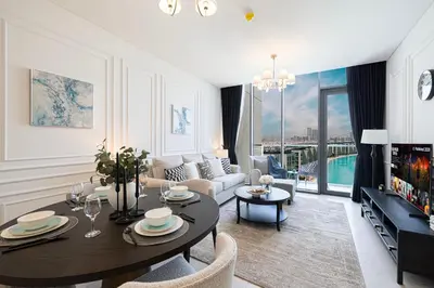 a living room with a table and chairs and a couch at Crystal Lagoon View Beach access Fast Wi-Fi in Dubai