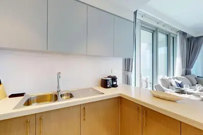 a kitchen with a sink and a counter top at Forte Tower 2 - Warm Two Bedroom in Dubai