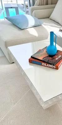 a bed with a book and a cup on top of it at Residences 29 - Divine Beachfront One Bedroom in Dubai