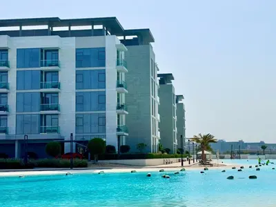 a large swimming pool in front of a building at Residences 29 - Divine Beachfront One Bedroom in Dubai