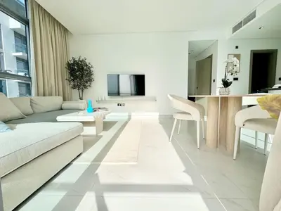 a living room with a couch and a table at Residences 29 - Divine Beachfront One Bedroom in Dubai