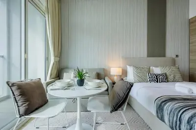 a bedroom with a bed and a table and chairs at Studio One - Gorgeous Studio in Dubai