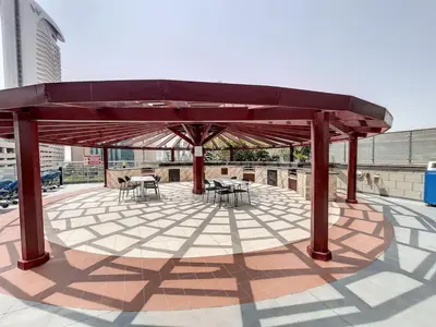 a pavilion with tables and chairs on a patio at Ocean Heights - Exquisite One Bedroom in Dubai