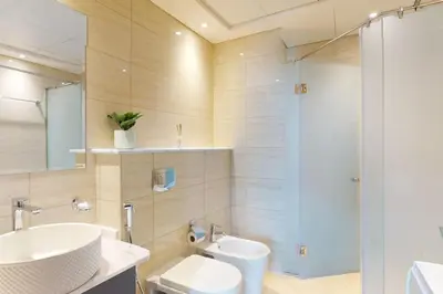 a bathroom with a sink and a toilet and a shower at Ocean Heights - Exquisite One Bedroom in Dubai