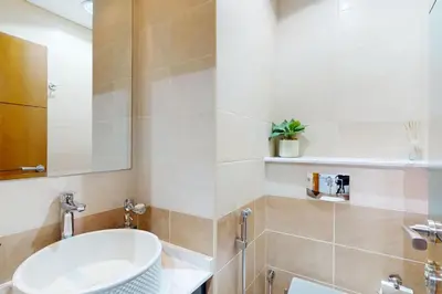 a bathroom with a sink and a mirror at Ocean Heights - Exquisite One Bedroom in Dubai