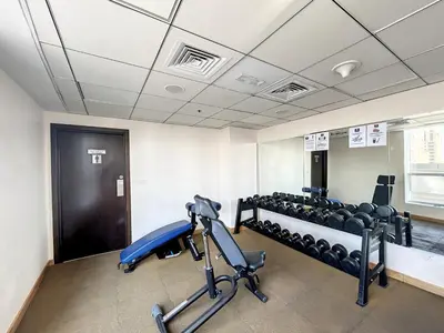 a room with a gym with chairs and a treadmill at Bay Central - Enticing Two Bedroom in Dubai