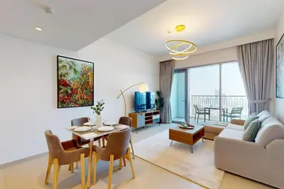 a living room with a table and a couch at Downtown Views II, Tower 2- Calm One Bedroom in Dubai