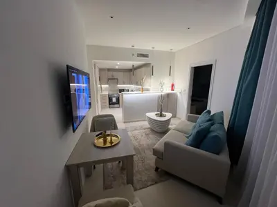 a living room with a couch and a table at SevenPalm 2BR SeaView RooftopPool privBeach in Dubai