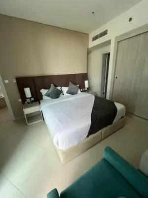 a bedroom with a large bed with white sheets and pillows at SevenPalm 2BR SeaView RooftopPool privBeach in Dubai