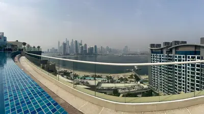 a swimming pool with a view of a city at SevenPalm 2BR SeaView RooftopPool privBeach in Dubai