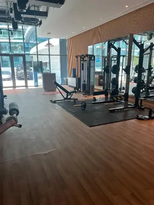 a gym with treadmills and machines in a building at SevenPalm 2BR SeaView RooftopPool privBeach in Dubai