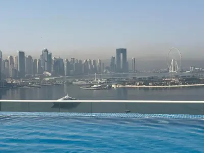 a swimming pool with a view of a city at SevenPalm 2BR SeaView RooftopPool privBeach in Dubai