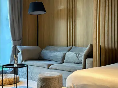 a living room with a couch and a bed at Ultra Luxury Flat Fully Upgrade with Balcony in Marina in Dubai