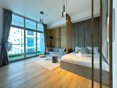 a bedroom with a bed and a couch at Ultra Luxury Flat Fully Upgrade with Balcony in Marina in Dubai